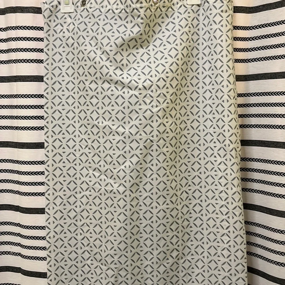 Shower curtain with teal flower design at bottom